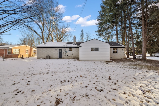 snow covered house with cooling unit