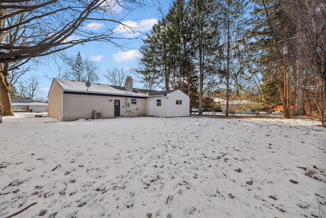 snow covered property with cooling unit