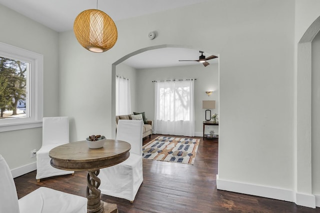 dining room with dark wood-type flooring and ceiling fan