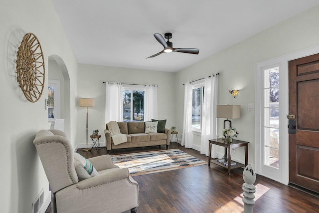 living room featuring plenty of natural light, dark hardwood / wood-style floors, and ceiling fan