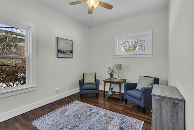 sitting room featuring ceiling fan, a healthy amount of sunlight, and dark hardwood / wood-style floors