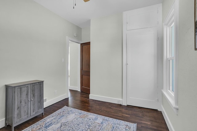 unfurnished bedroom with dark hardwood / wood-style flooring and ceiling fan