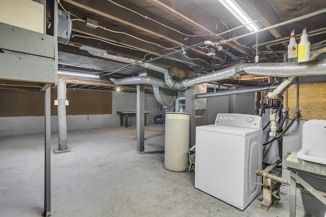 basement featuring washer / clothes dryer and water heater