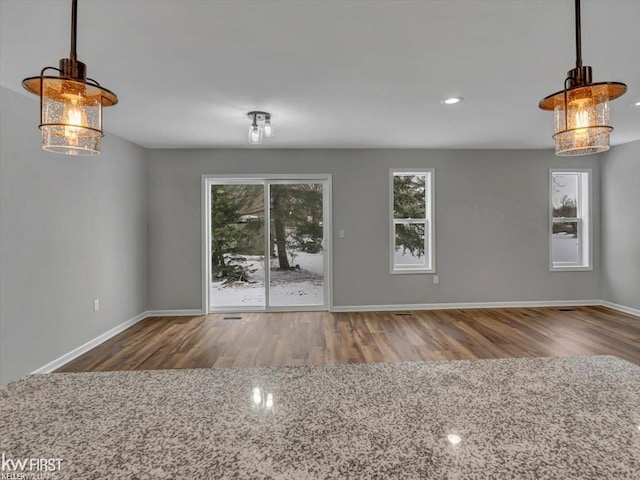 unfurnished living room featuring hardwood / wood-style floors