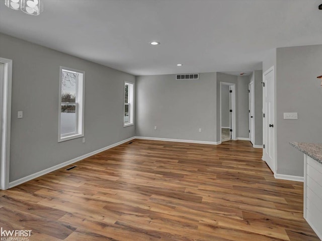 unfurnished living room with hardwood / wood-style floors