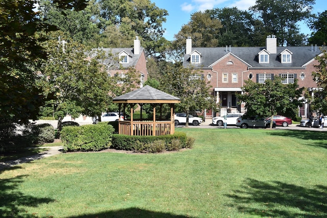 surrounding community with a gazebo and a lawn