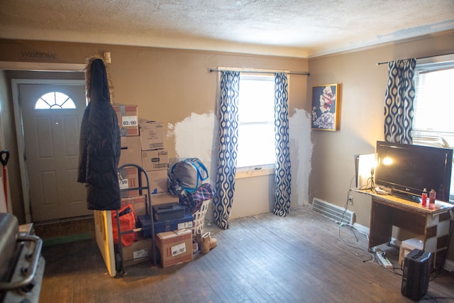 entryway with hardwood / wood-style flooring and a textured ceiling