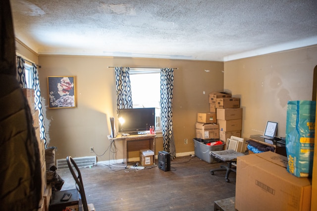 office featuring hardwood / wood-style flooring, a healthy amount of sunlight, and a textured ceiling