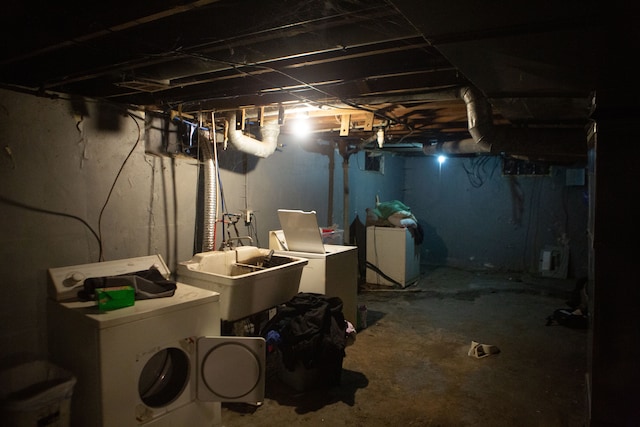 basement with washer and clothes dryer and sink