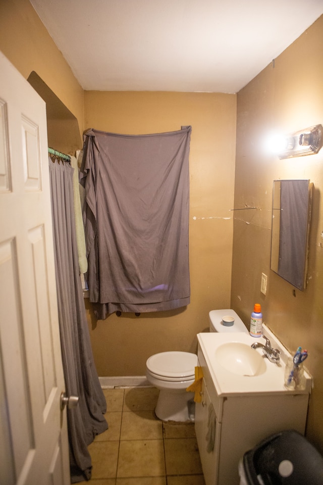 bathroom with tile patterned flooring, vanity, and toilet