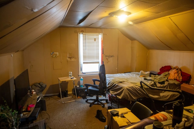 carpeted bedroom with lofted ceiling