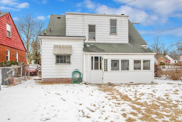 view of snow covered rear of property