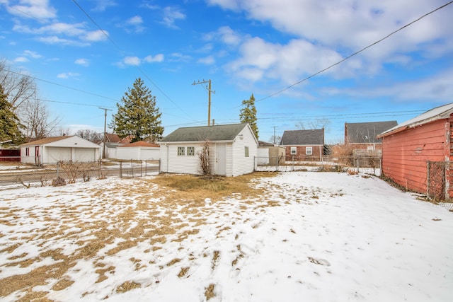 snowy yard featuring an outdoor structure