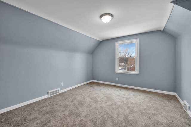 bonus room featuring vaulted ceiling and carpet flooring