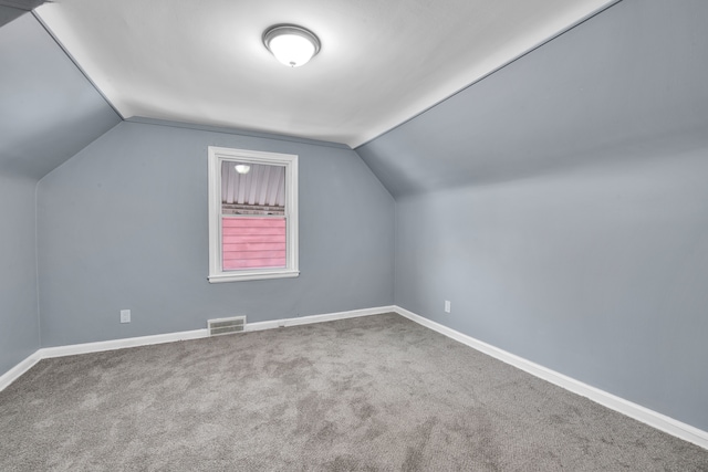 additional living space with lofted ceiling and carpet floors