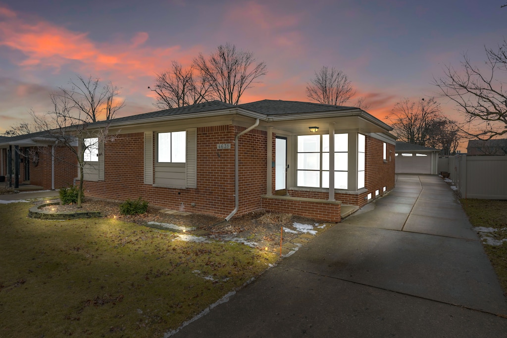 property exterior at dusk with an outbuilding and a garage