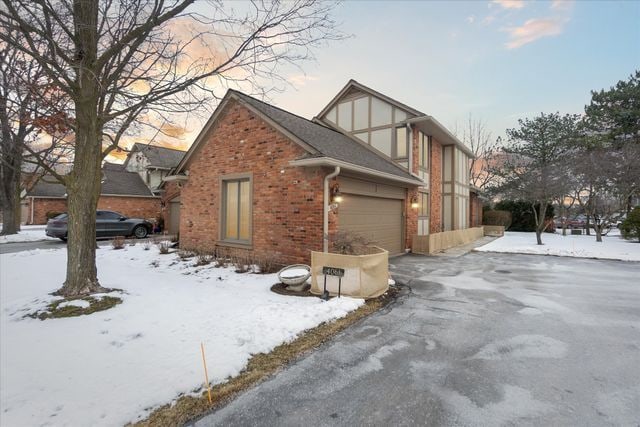 view of snowy exterior featuring a garage