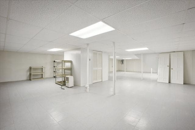 basement with a paneled ceiling