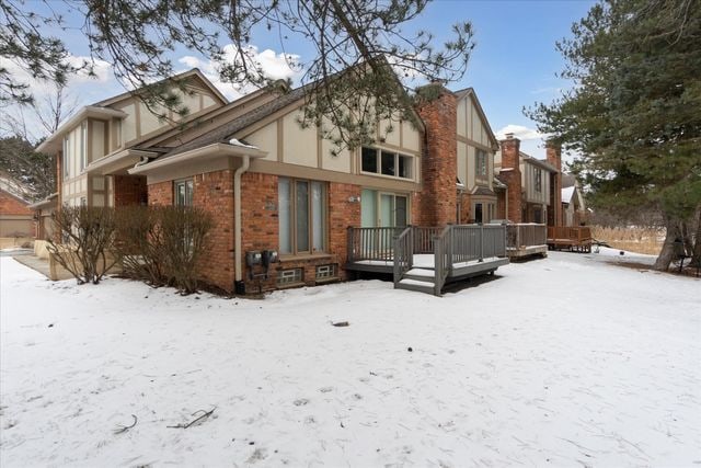 snow covered house with a deck