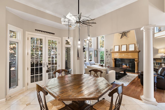 dining space with french doors, decorative columns, and light tile patterned floors