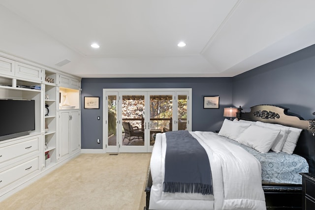 bedroom with light carpet, access to exterior, a raised ceiling, and french doors