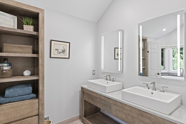 bathroom with vanity and vaulted ceiling