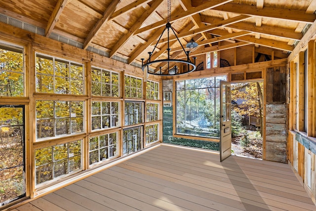 unfurnished sunroom with lofted ceiling