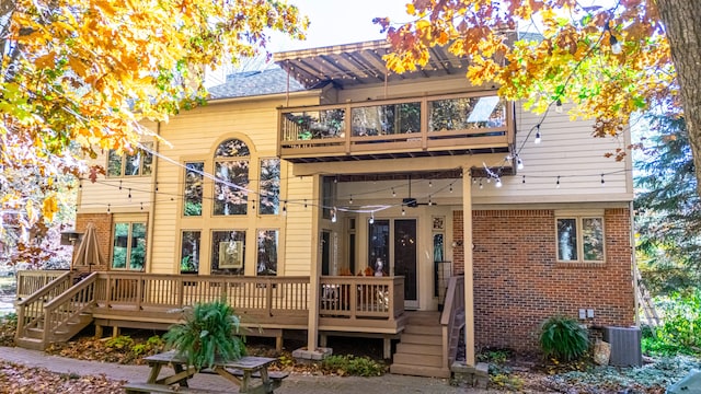 back of property featuring ceiling fan, a balcony, and central air condition unit