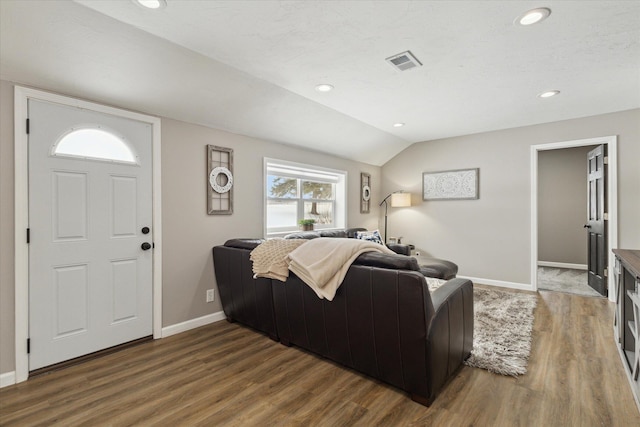 living room featuring lofted ceiling and wood-type flooring