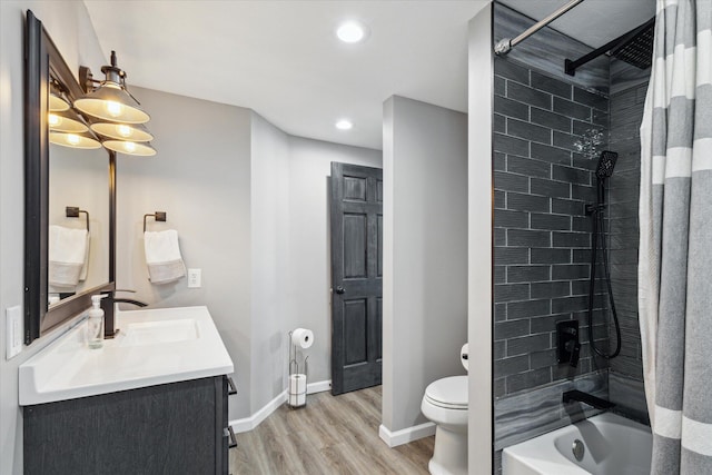 full bathroom featuring vanity, hardwood / wood-style floors, shower / tub combo, and toilet