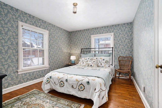 bedroom with dark hardwood / wood-style flooring