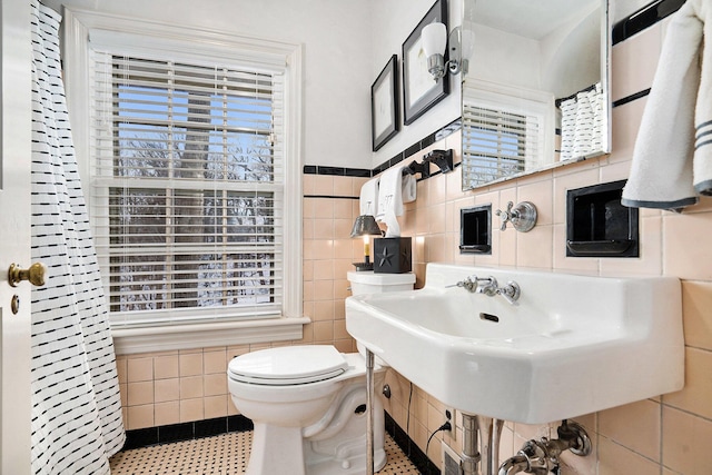 bathroom featuring tile walls, tile patterned flooring, plenty of natural light, and toilet