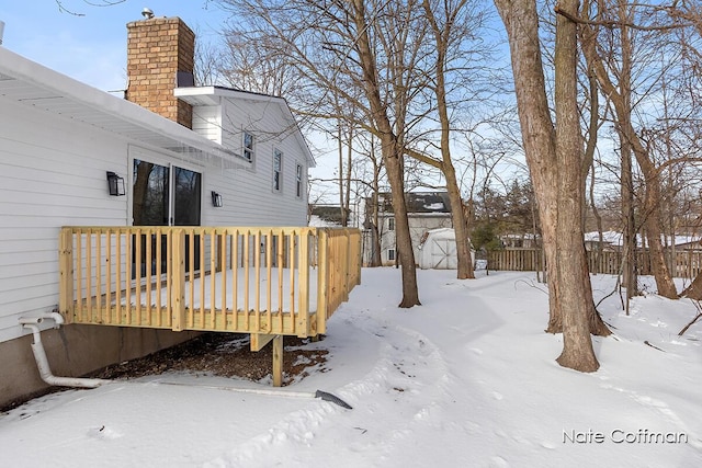 exterior space with a shed and a wooden deck