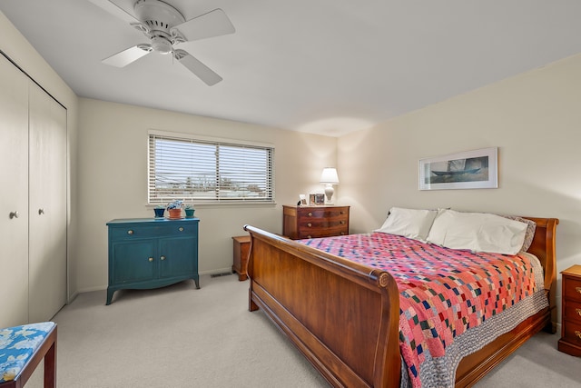 carpeted bedroom with ceiling fan and a closet