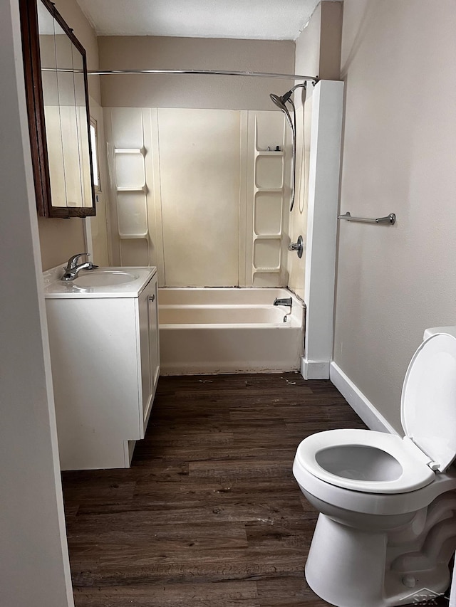 full bathroom featuring wood-type flooring, vanity, washtub / shower combination, and toilet