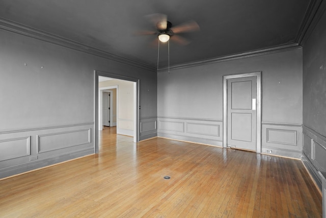 spare room featuring crown molding, ceiling fan, and hardwood / wood-style flooring