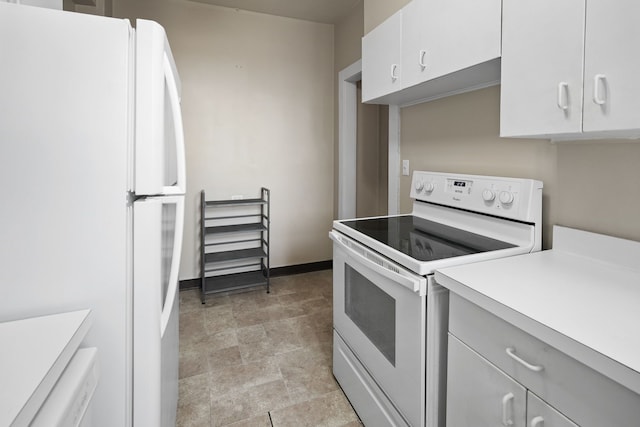 kitchen featuring white cabinetry and white appliances