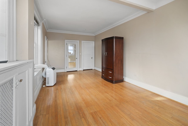 interior space featuring crown molding and light hardwood / wood-style flooring