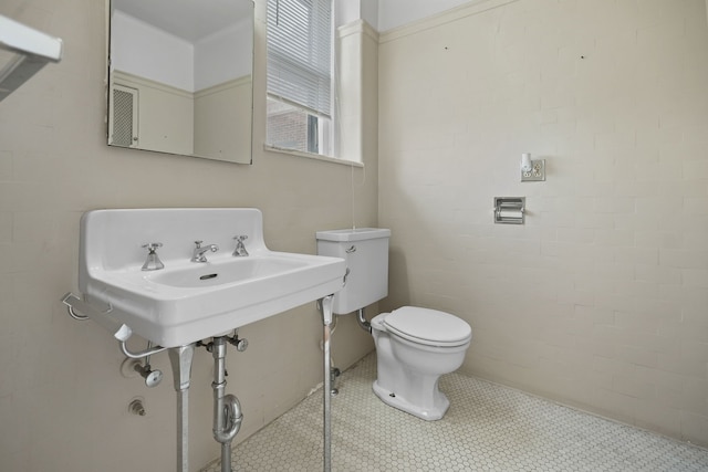 bathroom featuring tile patterned flooring and toilet