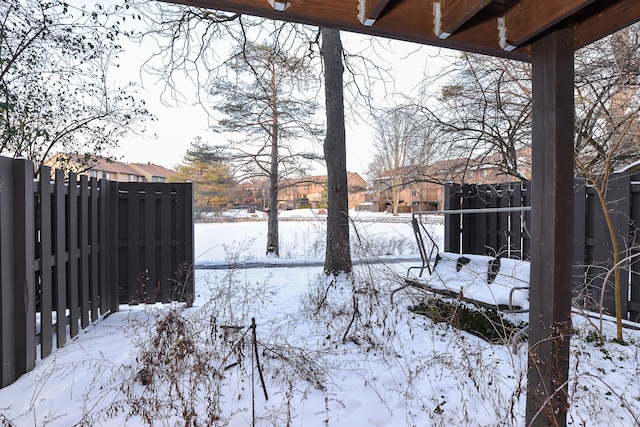 yard layered in snow with fence