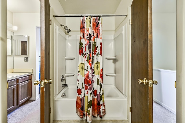 bathroom with shower / bath combination with curtain, vanity, and baseboards