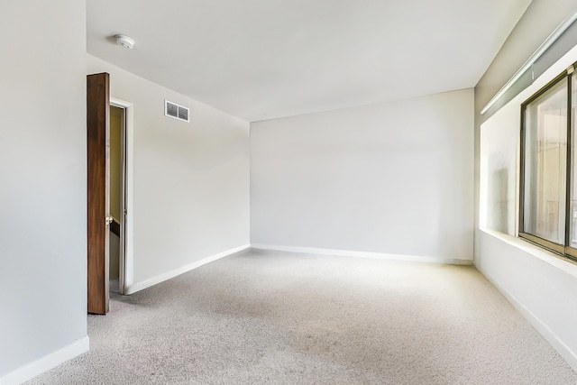 carpeted empty room with baseboards and visible vents