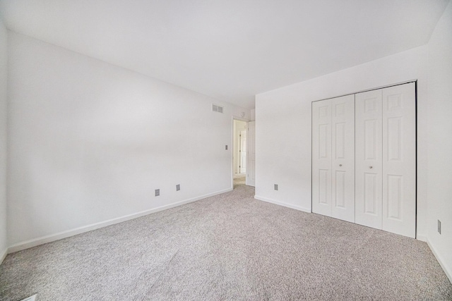 unfurnished bedroom with carpet floors and a closet