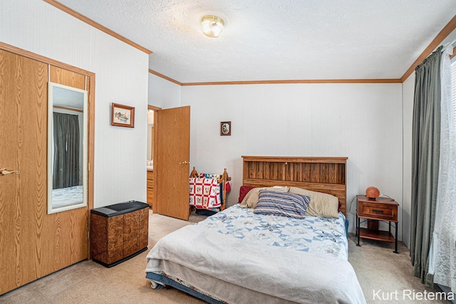 bedroom with ornamental molding, light colored carpet, and a textured ceiling