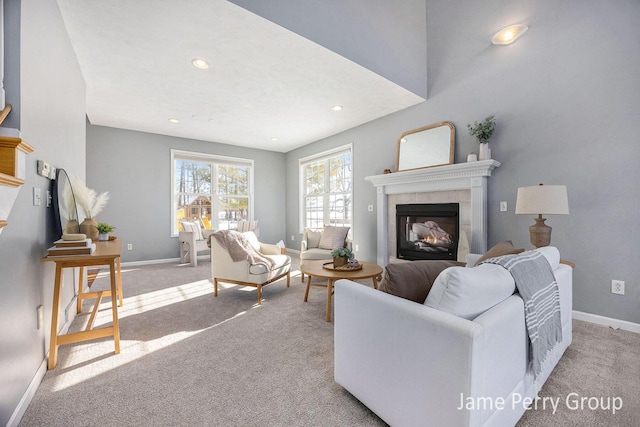 carpeted living room featuring a tile fireplace