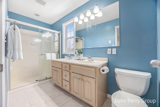 bathroom with walk in shower, tile patterned floors, vanity, and toilet