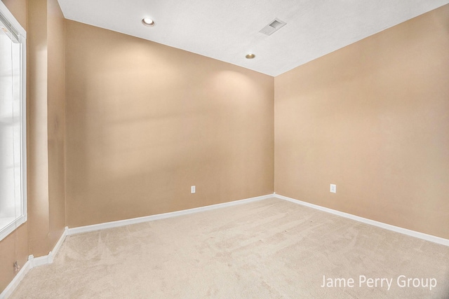 empty room with light colored carpet