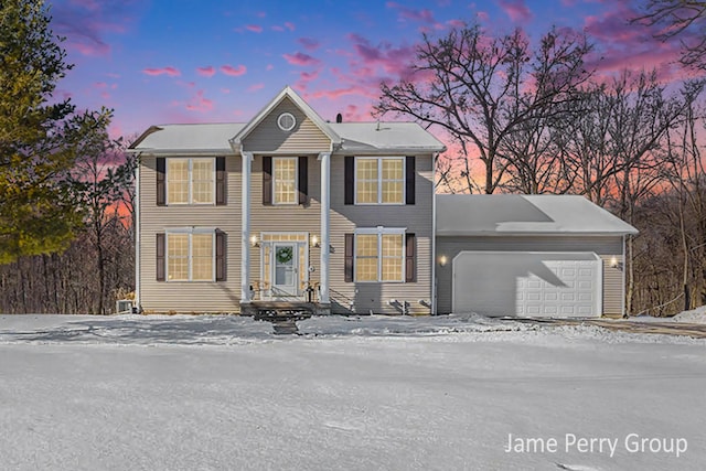 colonial inspired home featuring a garage