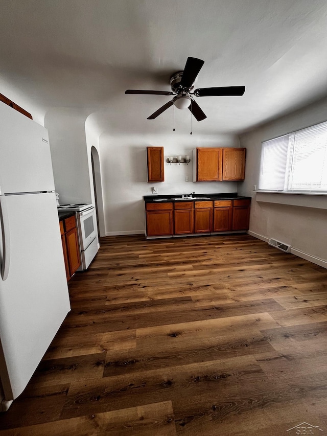 kitchen with white appliances, dark wood-type flooring, and ceiling fan