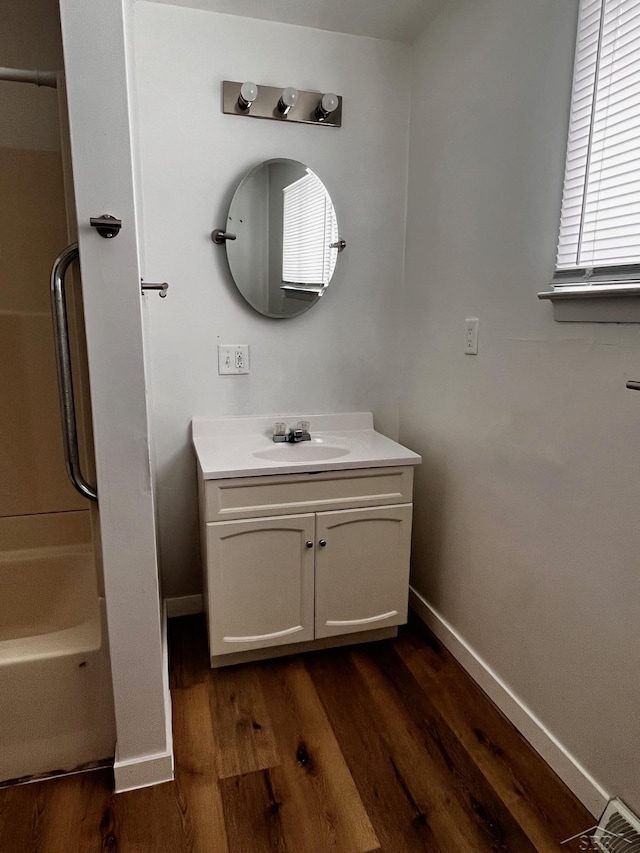 bathroom with vanity, bathtub / shower combination, and hardwood / wood-style floors